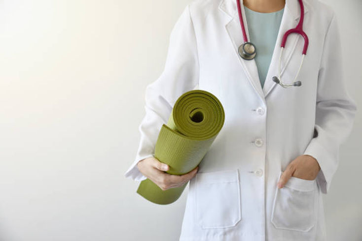 physician assistant holding yoga mat